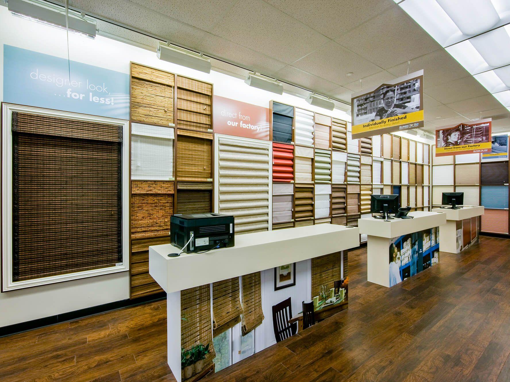 The wall of the Blinds To Go showroom shows a variety of products on display.