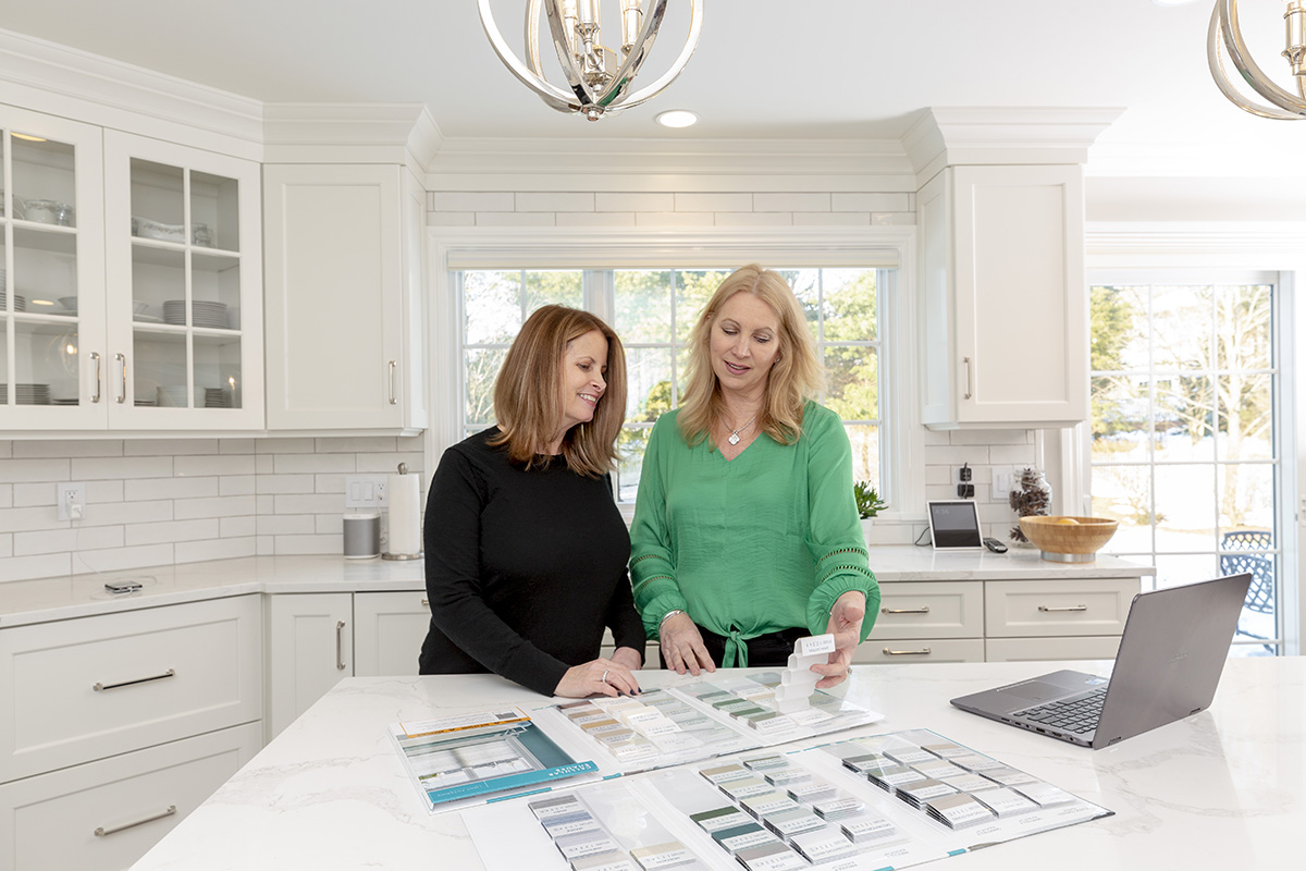 Two women in the kitchen having a free in-home window treatment consultation