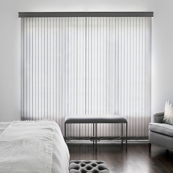 A trendy bedroom features light grey fabric vertical blinds.