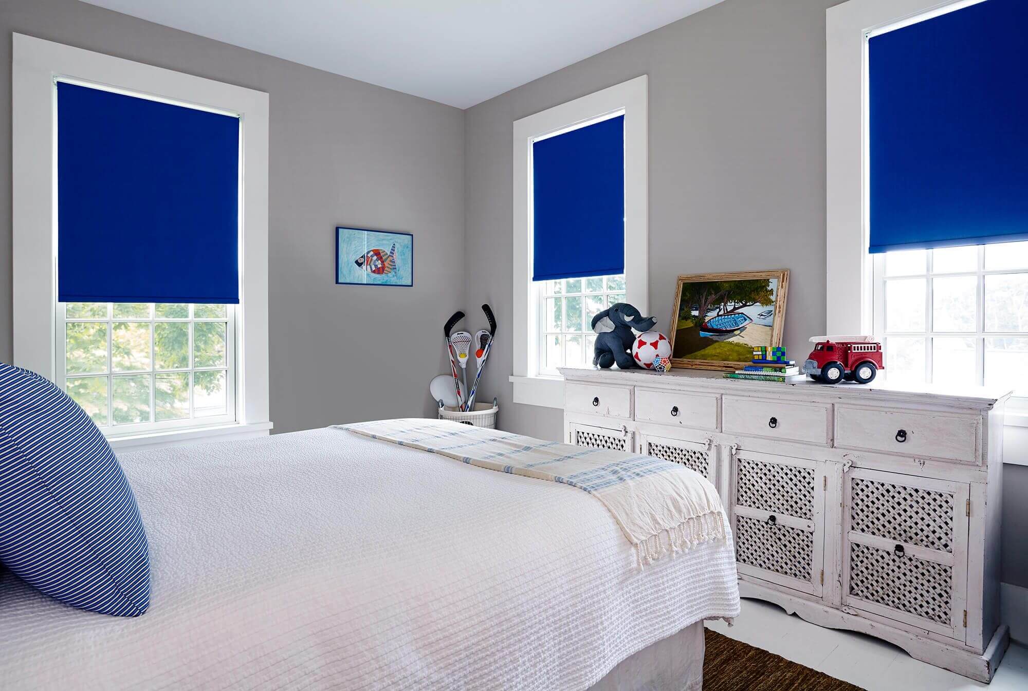 Custom roller shades provide the perfect balance of light and darkness for a child's bedroom.
