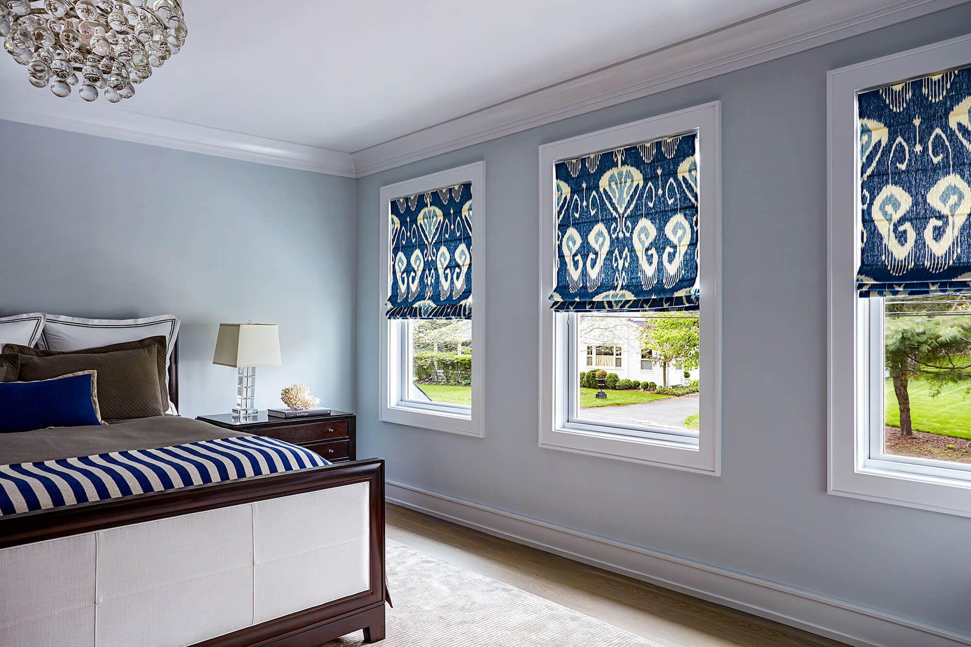 Stylish Roman Shades with flat fold style in a bedroom