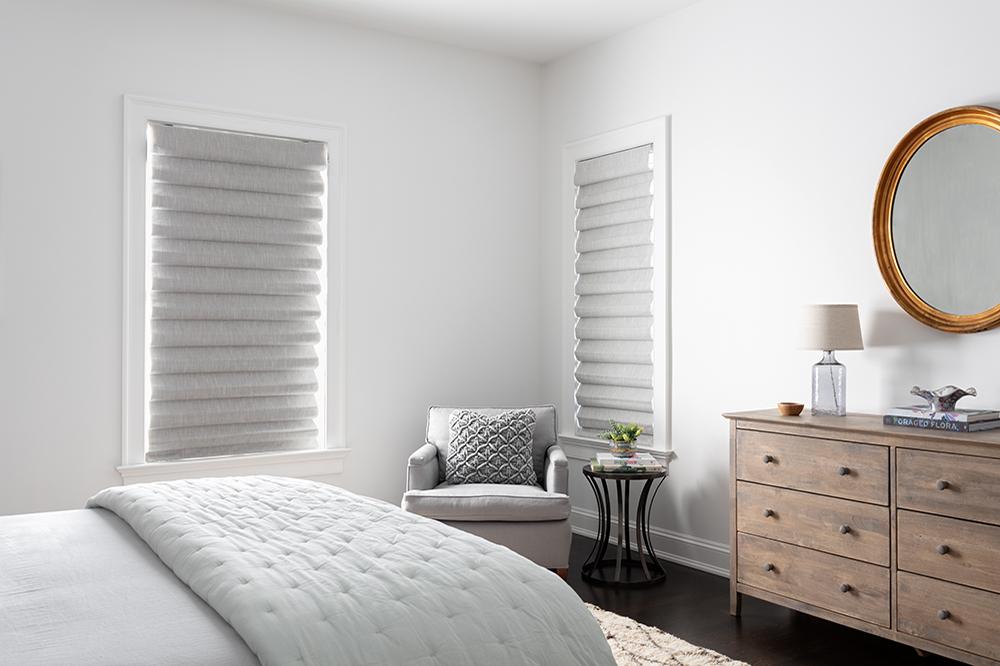 In a contemporary bedroom, Roman shades that are closed offer privacy.