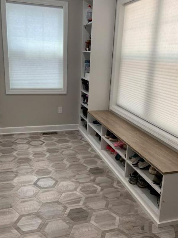 Cellular shades insulate a mudroom