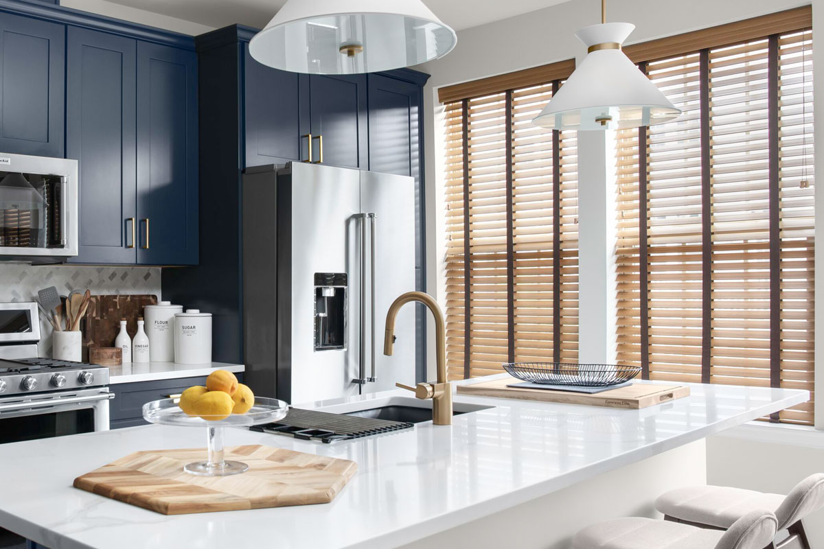 Aire wood faux wood blinds in a tan wood tone color are elegant and lightweight in a modern kitchen.
