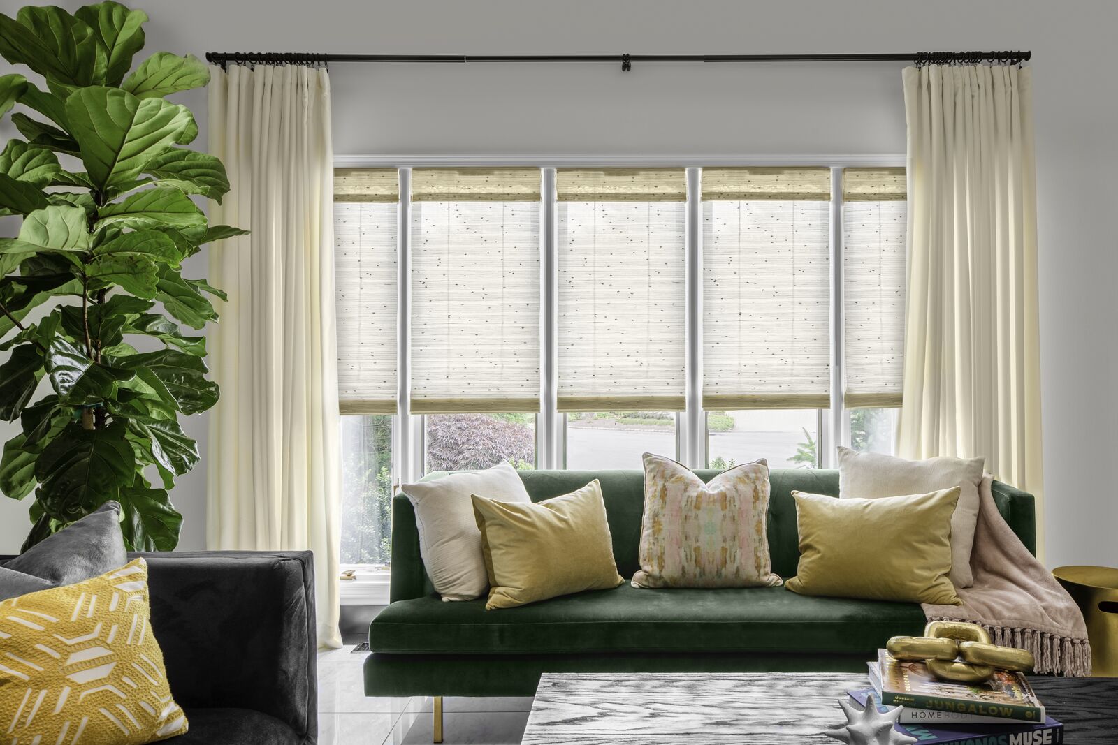 Woven wood shades in the closed position allow light to pour into a living room.