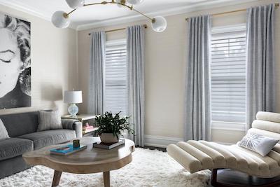 Curtains paired with Serenity sheer shades cover three windows in a contemporary style living room.