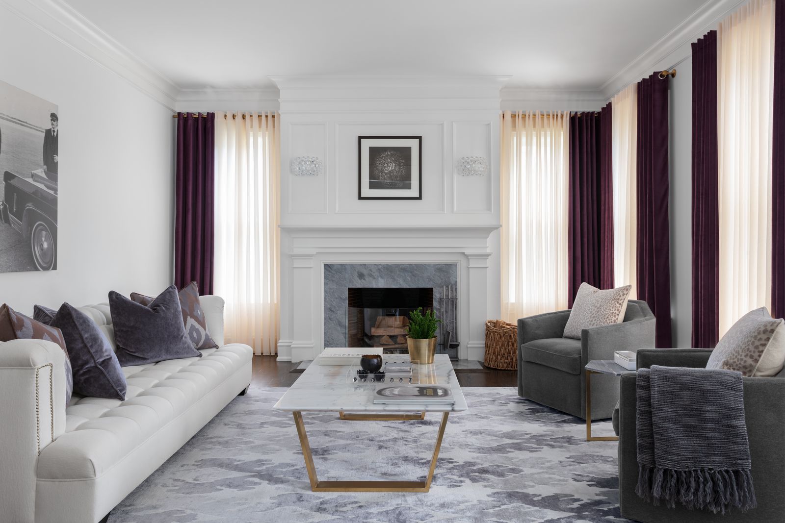 Purple velvet drapes share a rod with cream sheers on four large windows in a modern living room.