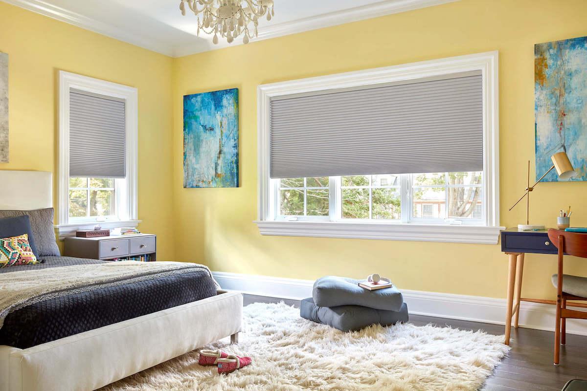 Sterling colored cellular shades with blackout lining in a yellow bedroom