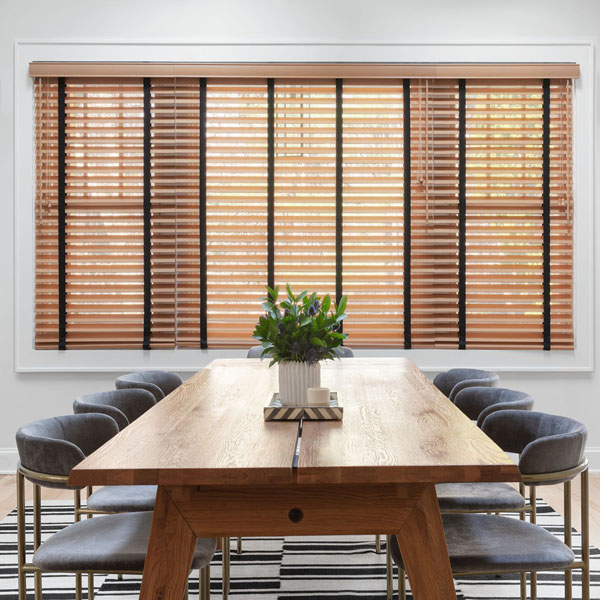 A dining room with natural wood blinds.