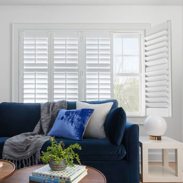 Bright and airy living room with white plantation shutters that provide privacy and style.