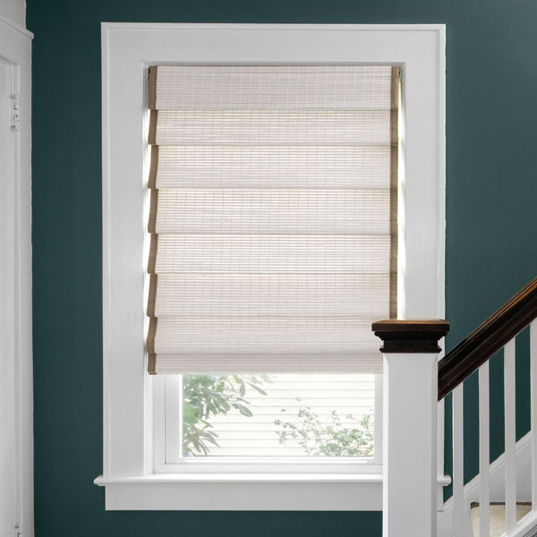 White classic fold, woven wood shades with tan fabric tape trim dress up a modern home entryway. 