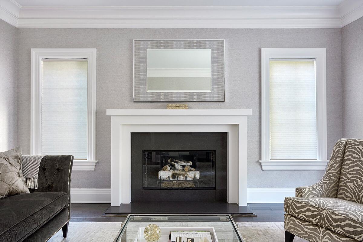 Smartcell ll - Spun Cotton cellular shade in the living room windows on each side of the fireplace.