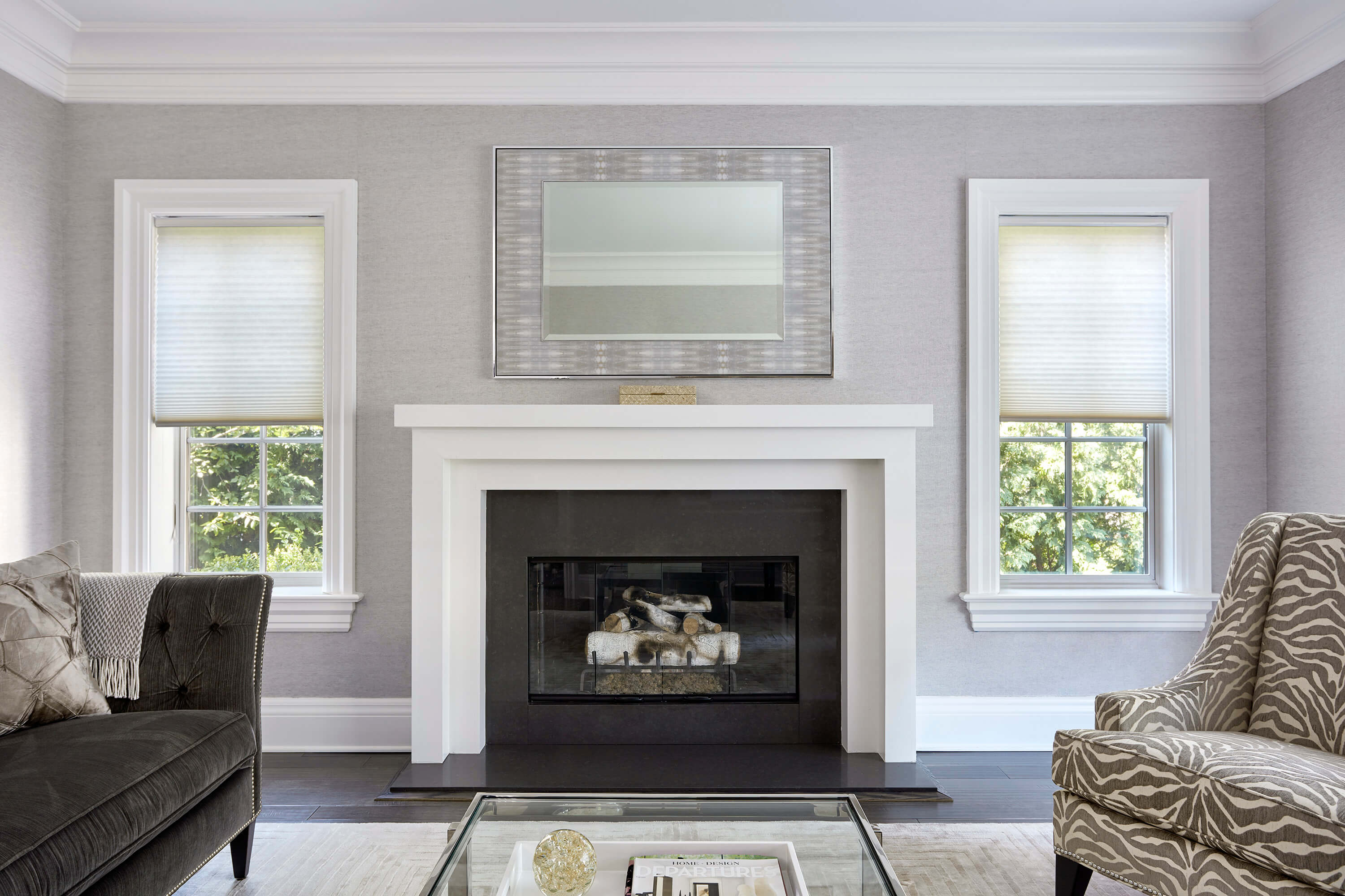 Cream-colored roman shades are showcased in a contemporary living room with a fireplace