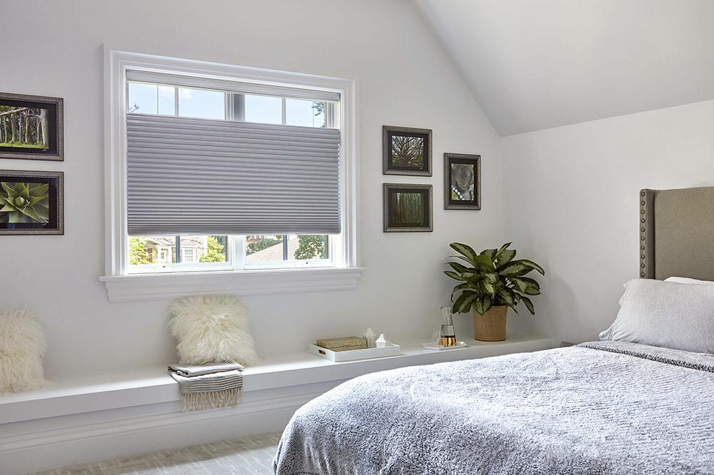 A bedroom features blackout cellular shades with top-down bottom-up option