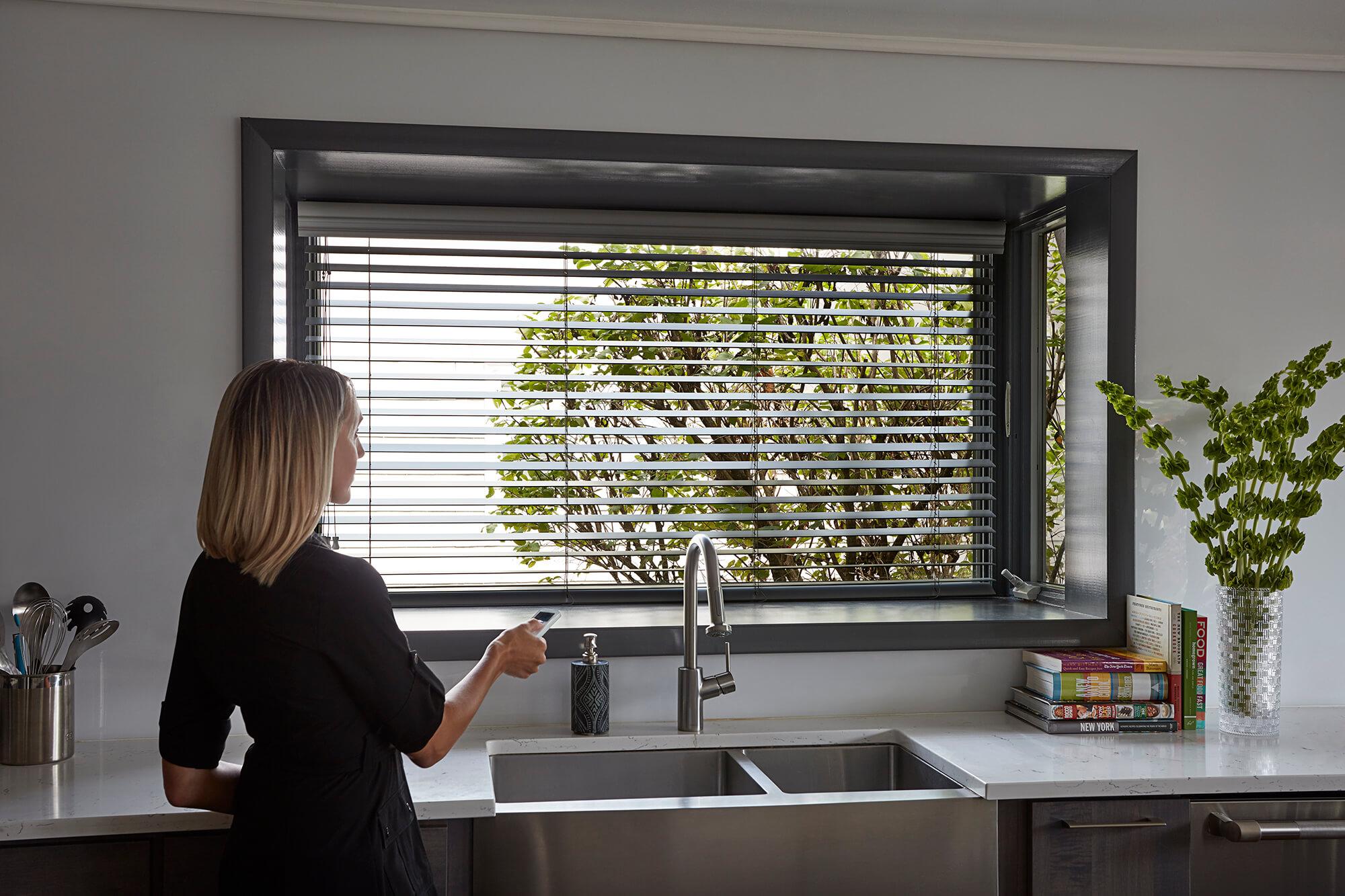 A large kitchen picture window features motorized shades.
