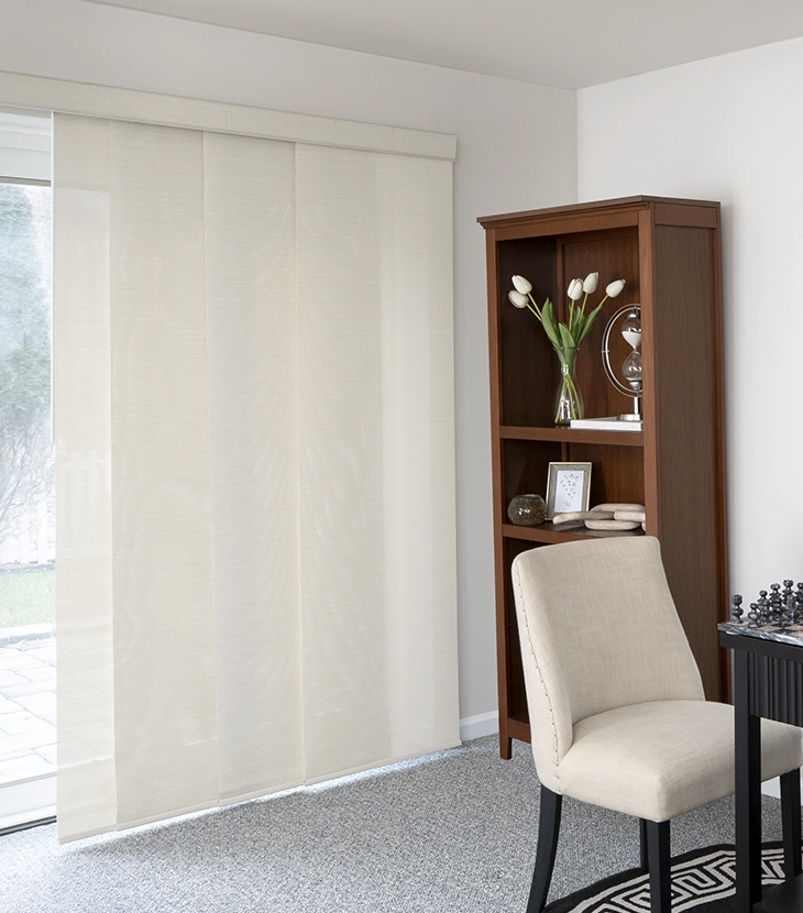 Cream-colored panel tracks partially cover a large sliding glass door in a modern home.