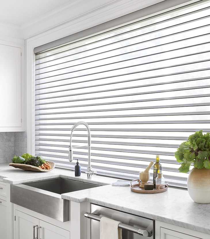 A large kitchen window is covered with a Serenity sheer shade.
