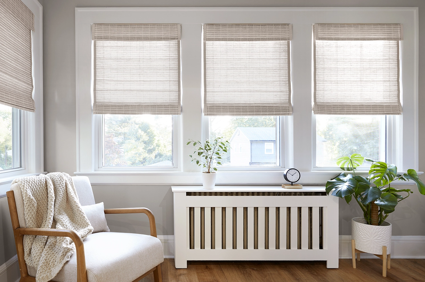 Woven wood shades allow light to pour into a modern sitting room.