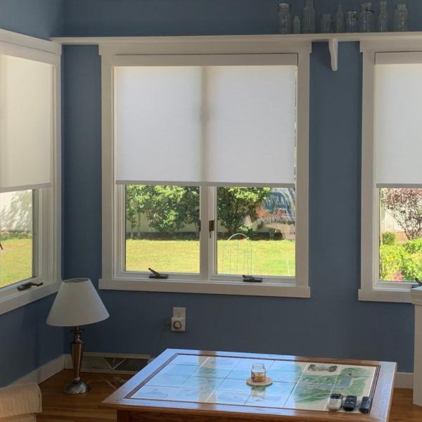 Natural light and privacy with white roller shades