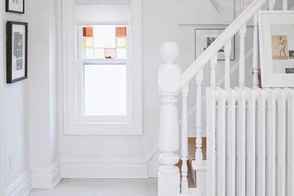 White cellular shades bring light in to an entryway