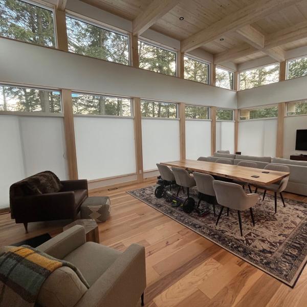 Huge windows with roller shades in a modern cabin