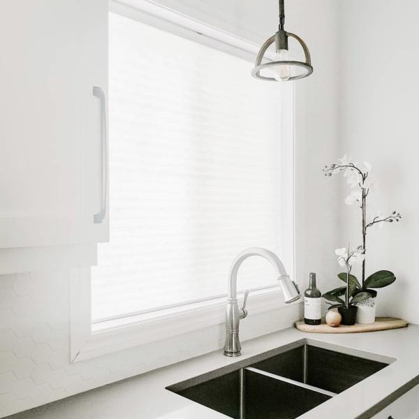 White cellular shades in a calming kitchen