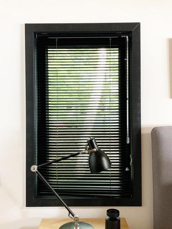 Aluminum blinds look custom in a black window frame 
