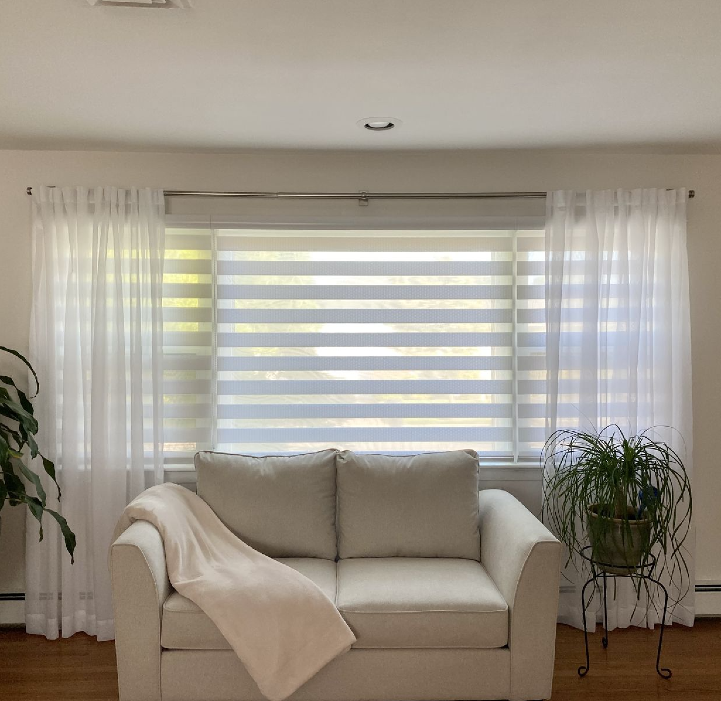 Cascade sheer shades paired with airy sheer curtains