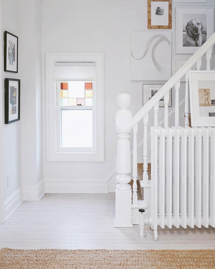 White cellular shades bring light in to an entryway