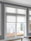 Light-filtering roller shades, raised halfway to showcase the scenic waterscape.