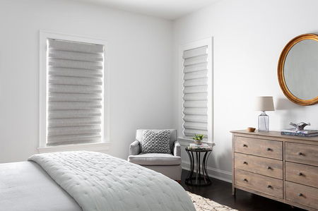 Classic fold roman shades in light grey cover two windows in a modern bedroom Classic fold roman shades in light grey cover two windows in a modern bedroom