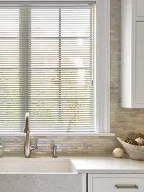 Aluminum blinds above the sink, providing a sleek, durable, and moisture-resistant window solution