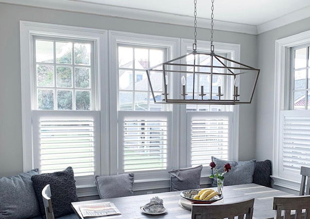 Café shutters offer privacy with a view in a sunlit dining room Café shutters offer privacy with a view in a sunlit dining room