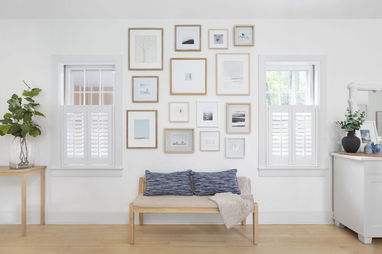 Cafe shutters cover two windows in a modern sitting room.