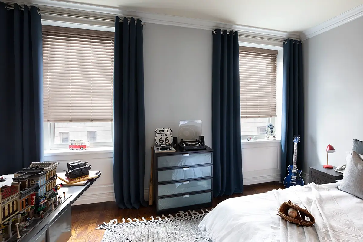Drapes paired with aluminum blinds in a child's room Drapes paired with aluminum blinds in a child's room