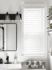 Faux wood blinds in the kitchen, providing a durable, moisture-resistant, and stylish window treatment option