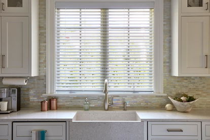 Faux window blinds against window on kitchen sink Faux window blinds against window on kitchen sink