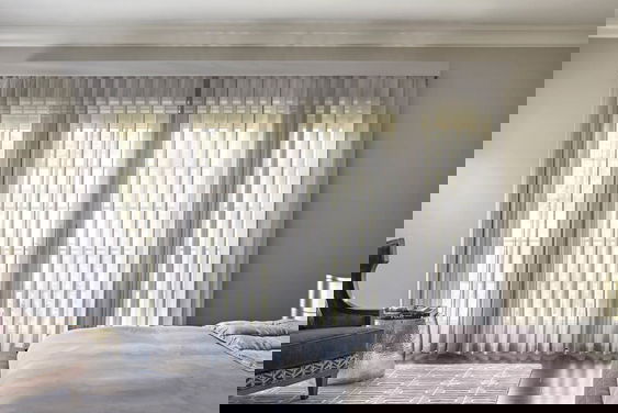 Elegant Melody vertical sheers in soft white, offering light filtering and privacy for large windows.