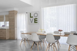 Vertical sheers offer privacy and tons of light in a modern kitchen