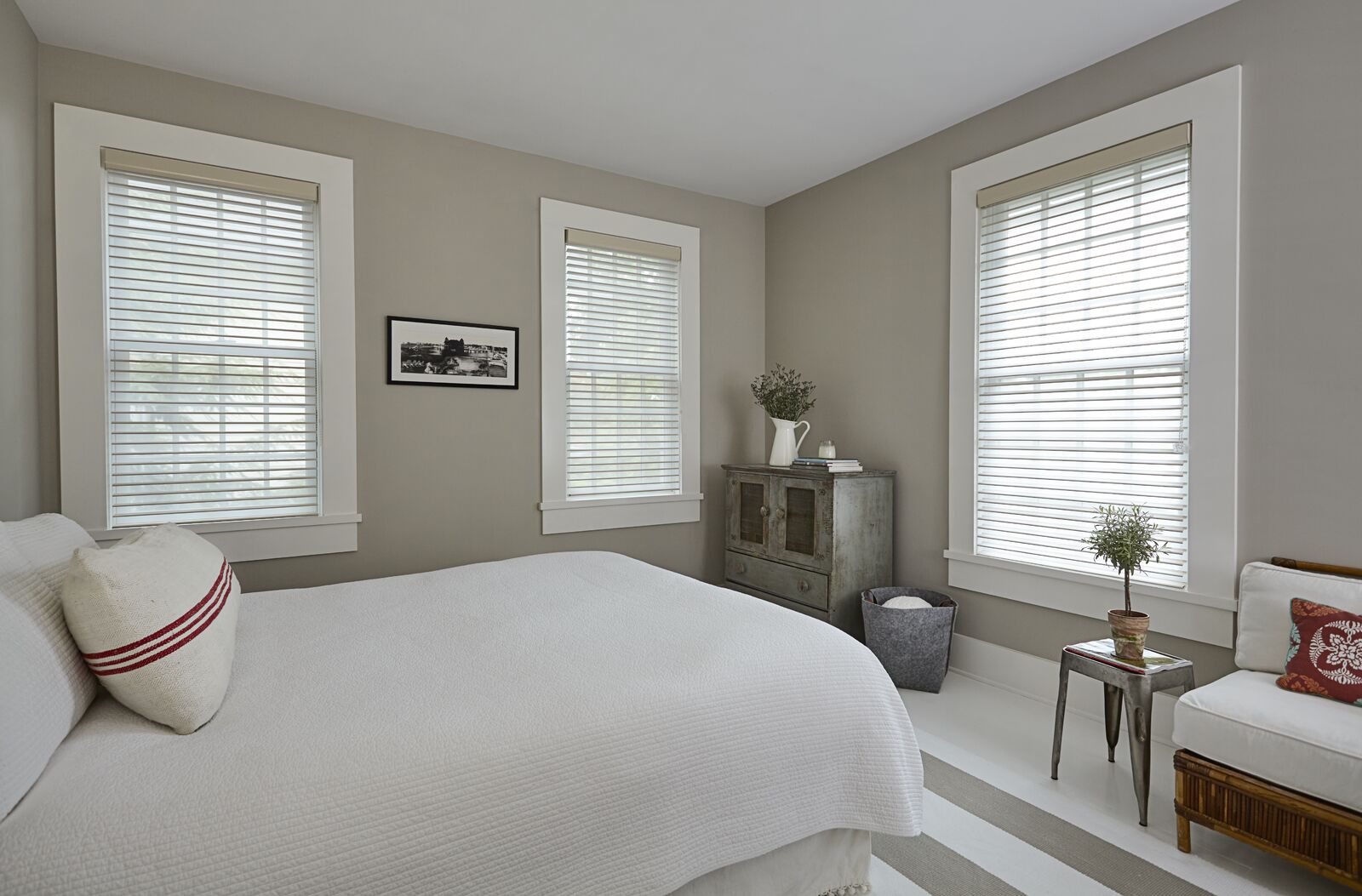Cream-colored Serenity sheer shades cover three windows in a modern bedroom Cream-colored Serenity sheer shades cover three windows in a modern bedroom