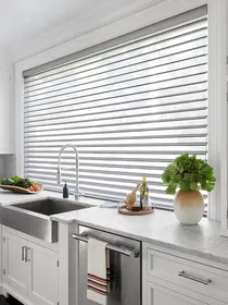 Serenity sheer shades cover a large kitchen window allowing light to fill the kitchen while providing day time privacy