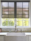 Solar shades cover a large window behind the sink in a modern farmhouse kitchen.