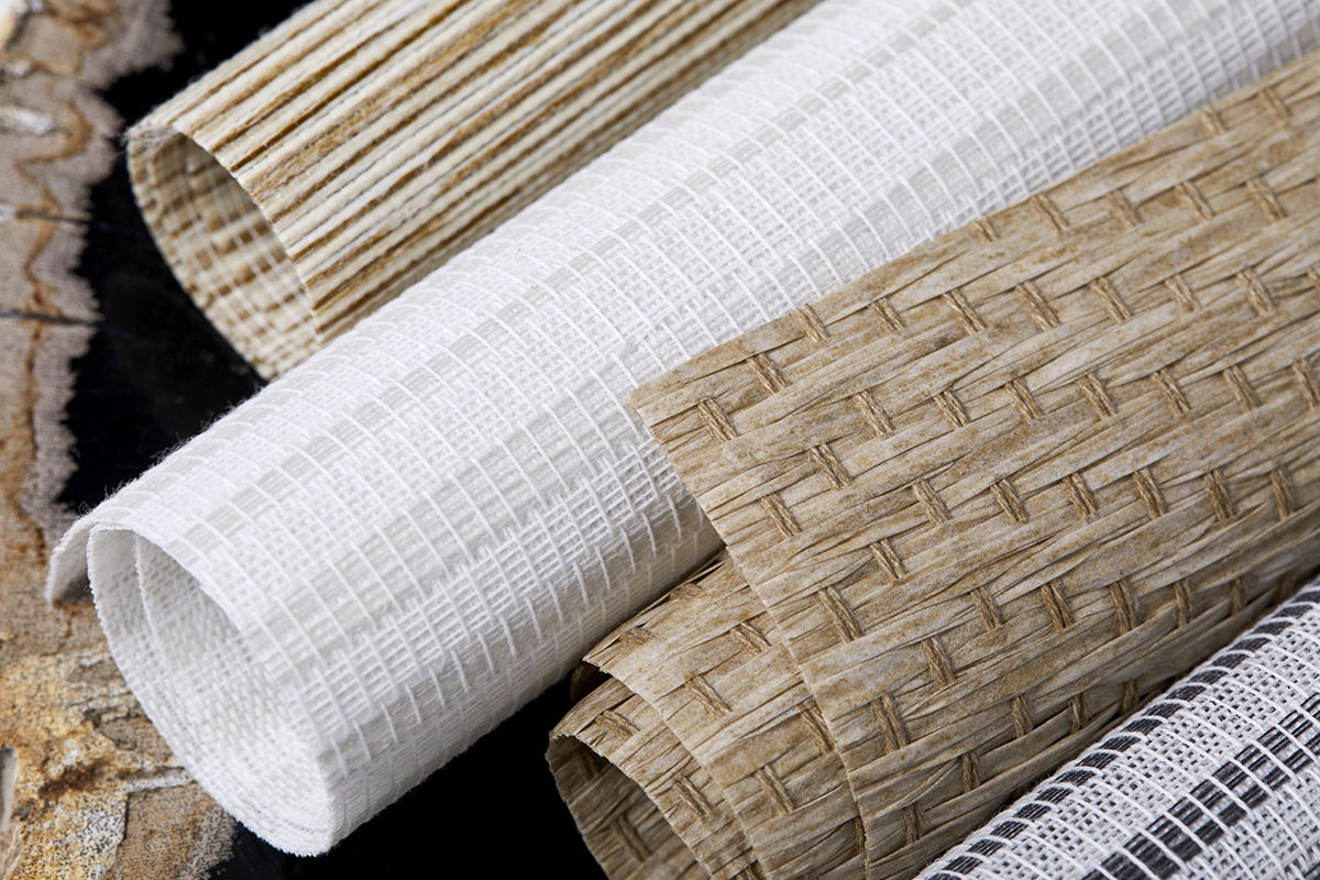 A close up image of woven wood shade swatches shows the beautiful texture and natural colors available. A close up image of woven wood shade swatches shows the beautiful texture and natural colors available.