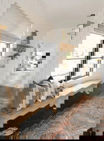 Entryway with elegant blinds enhancing the space's brightness.