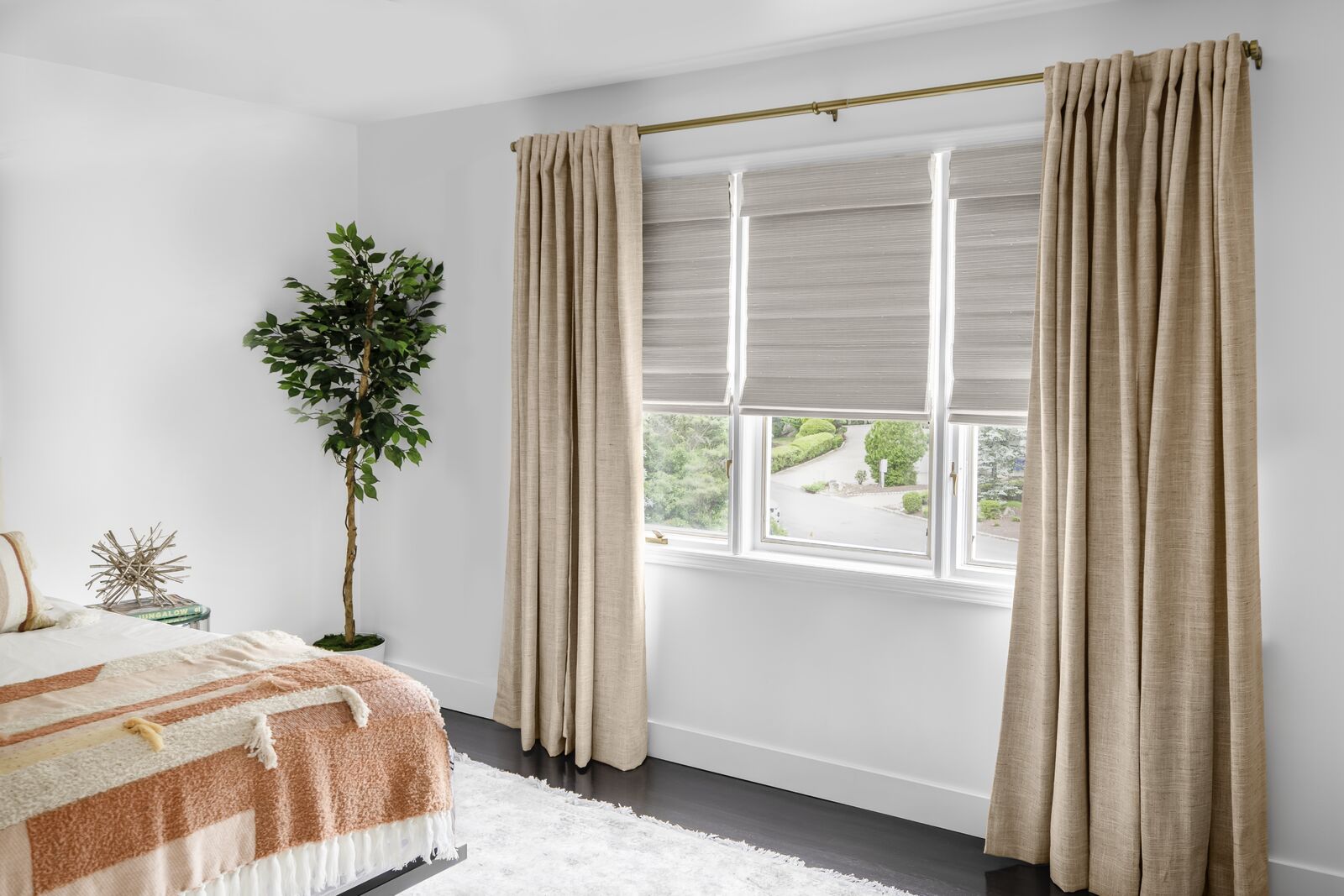 large window by layering curtains Lined woven wood shades paired with curtains